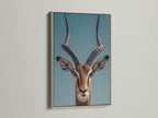 A close up of an Impala art print is displayed. The print is framed in a natural oak frame. The frame enhances the artwork. The frame adds warmth to the room.