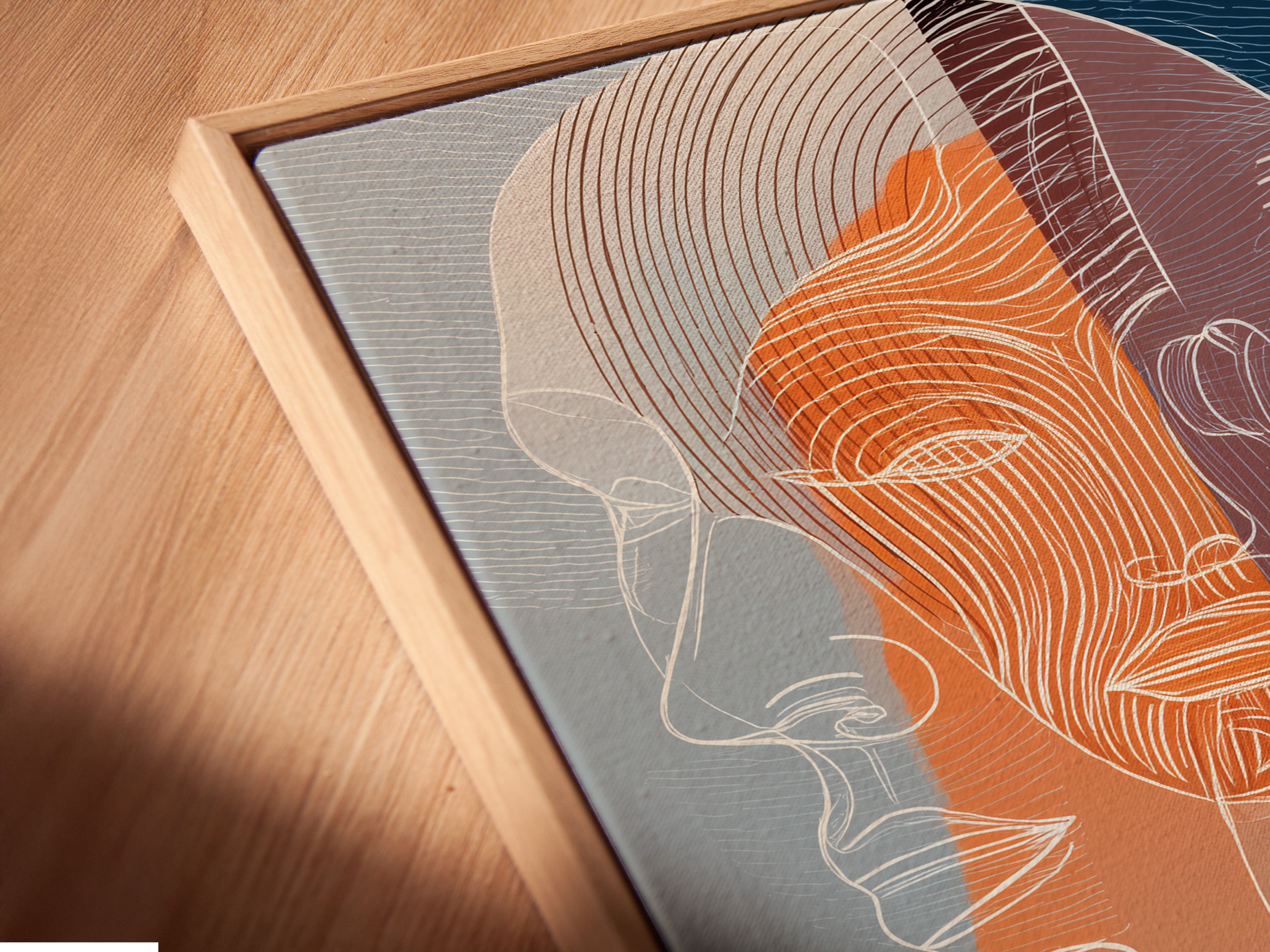 Angled close up reveals a canvas print in a floating frame. The floating frame gives the illusion of artwork suspended in air. This modern framing technique adds depth and dimension. Explore the unique appeal of floating frames for your art.