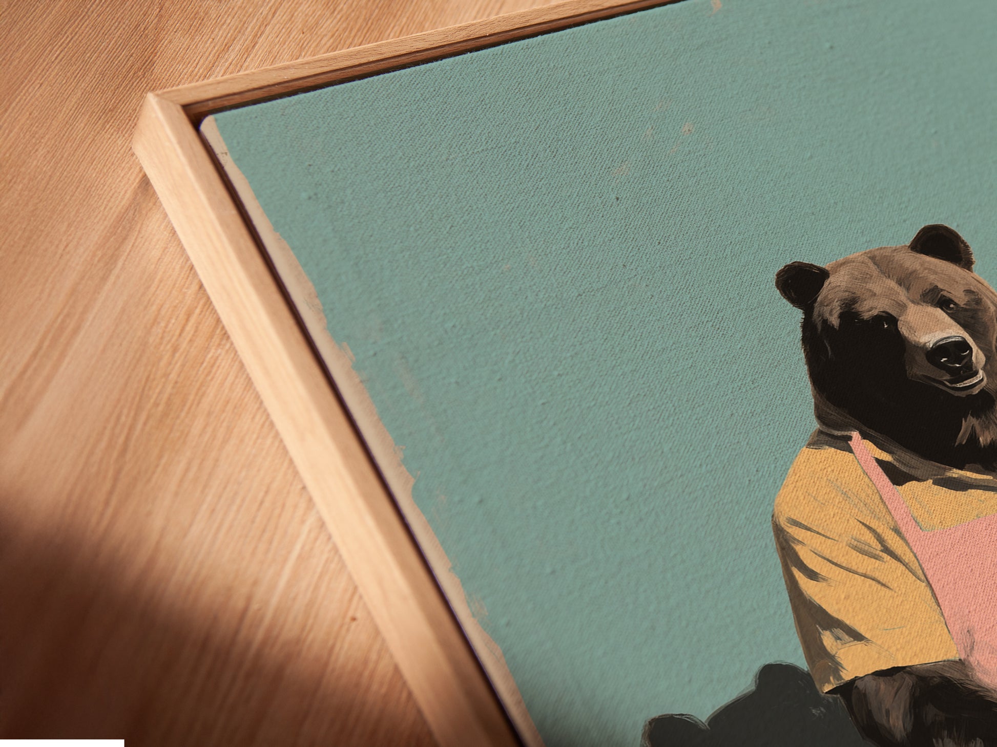 Angled close up of a canvas print in a floating frame. The bear baker artwork is prominently displayed. This is perfect for adding to your kitchen. It's a great piece of quirky wall art. The art brings culinary charm to your home.