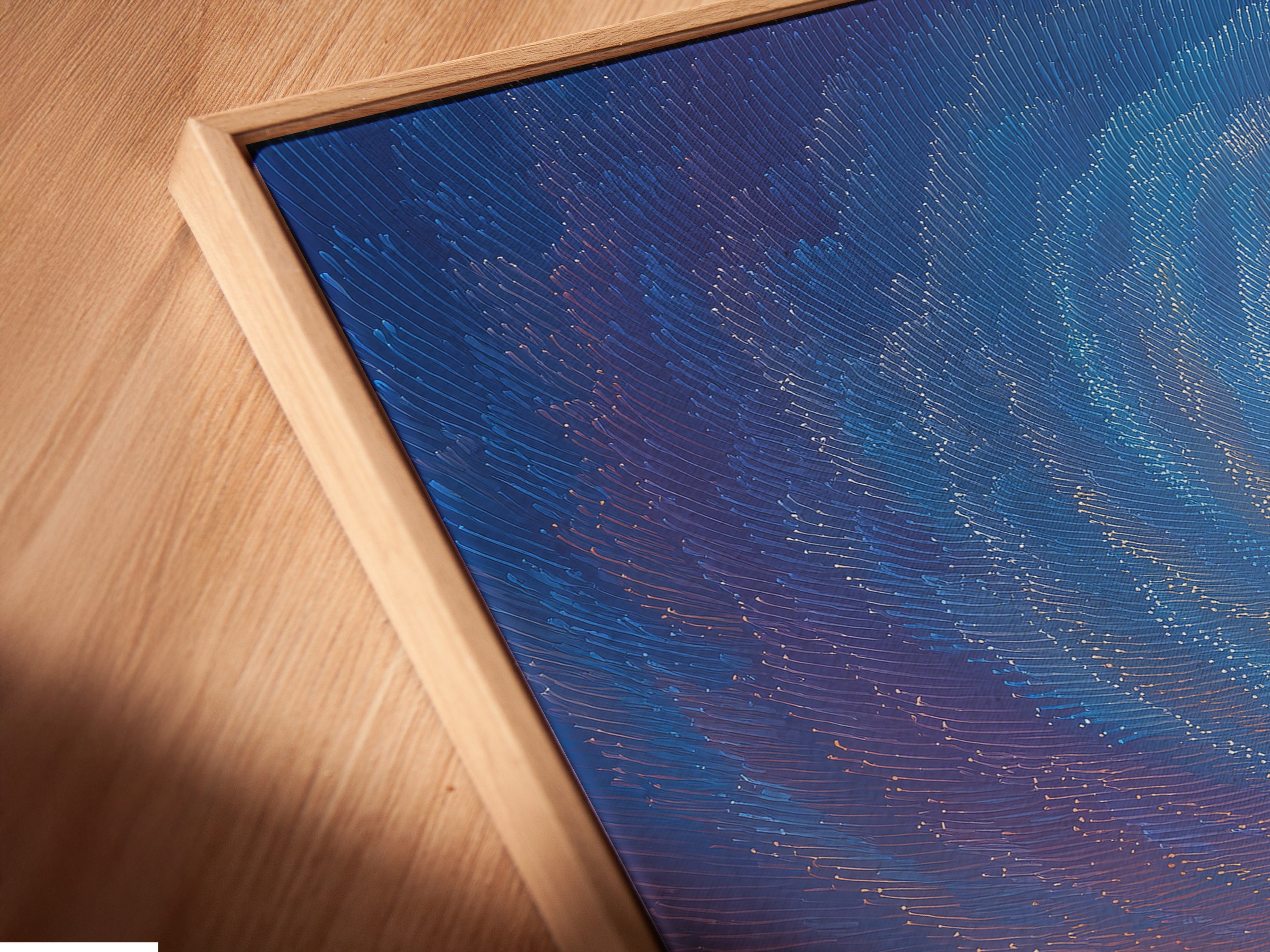 Close-up of a canvas print in a floating frame. The frame creates a modern gallery look. It separates the art from the wall. This enhances the artwork's visual impact. Perfect for contemporary homes and art collections. The floating frame adds depth and dimension.