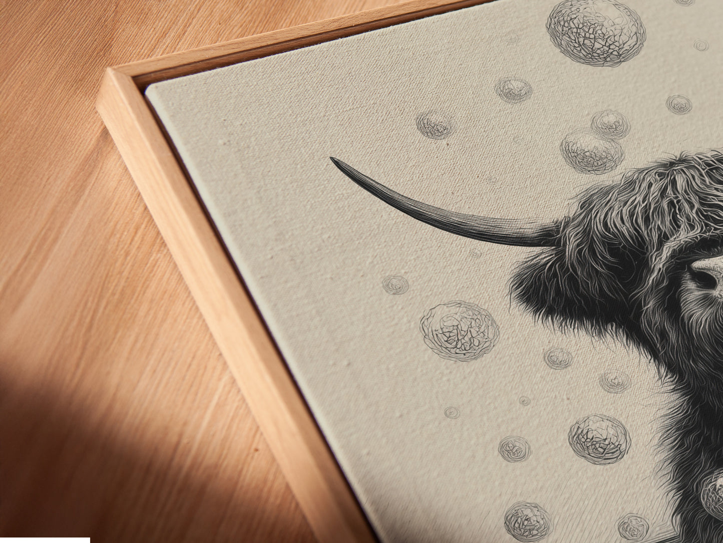 A close-up angled view features a canvas print. The artwork is displayed in a floating frame. The highland cow art piece adds humor. It's perfect as funny bathroom wall art. Enhance your farmhouse decor with this charming animal canvas art.