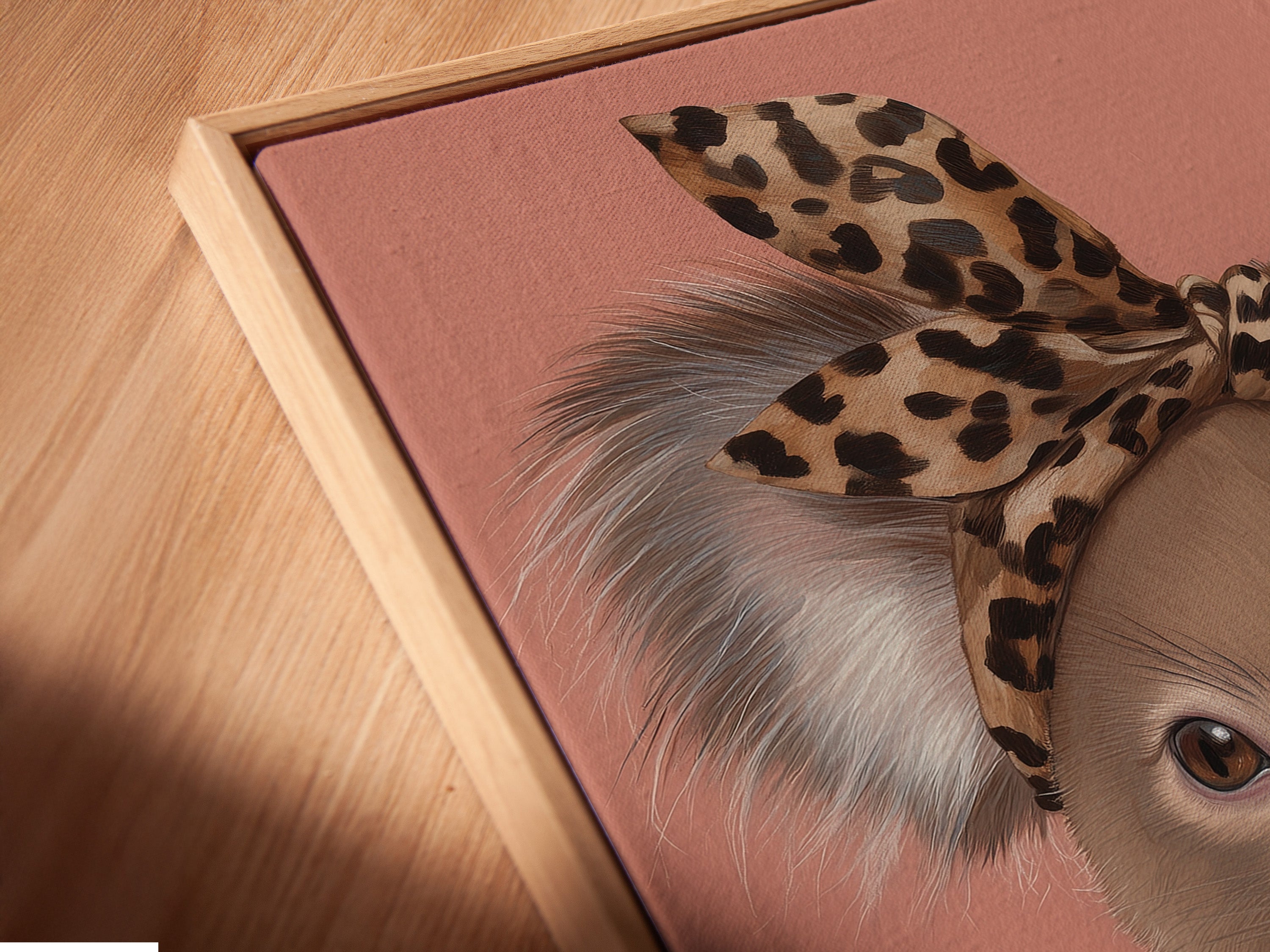 Angled close-up reveals the canvas print in a floating frame. The Koala Wall Art is trendy and modern. The artwork features a Koala with a leopard print headband and pearl necklace. It is perfect for nurseries.