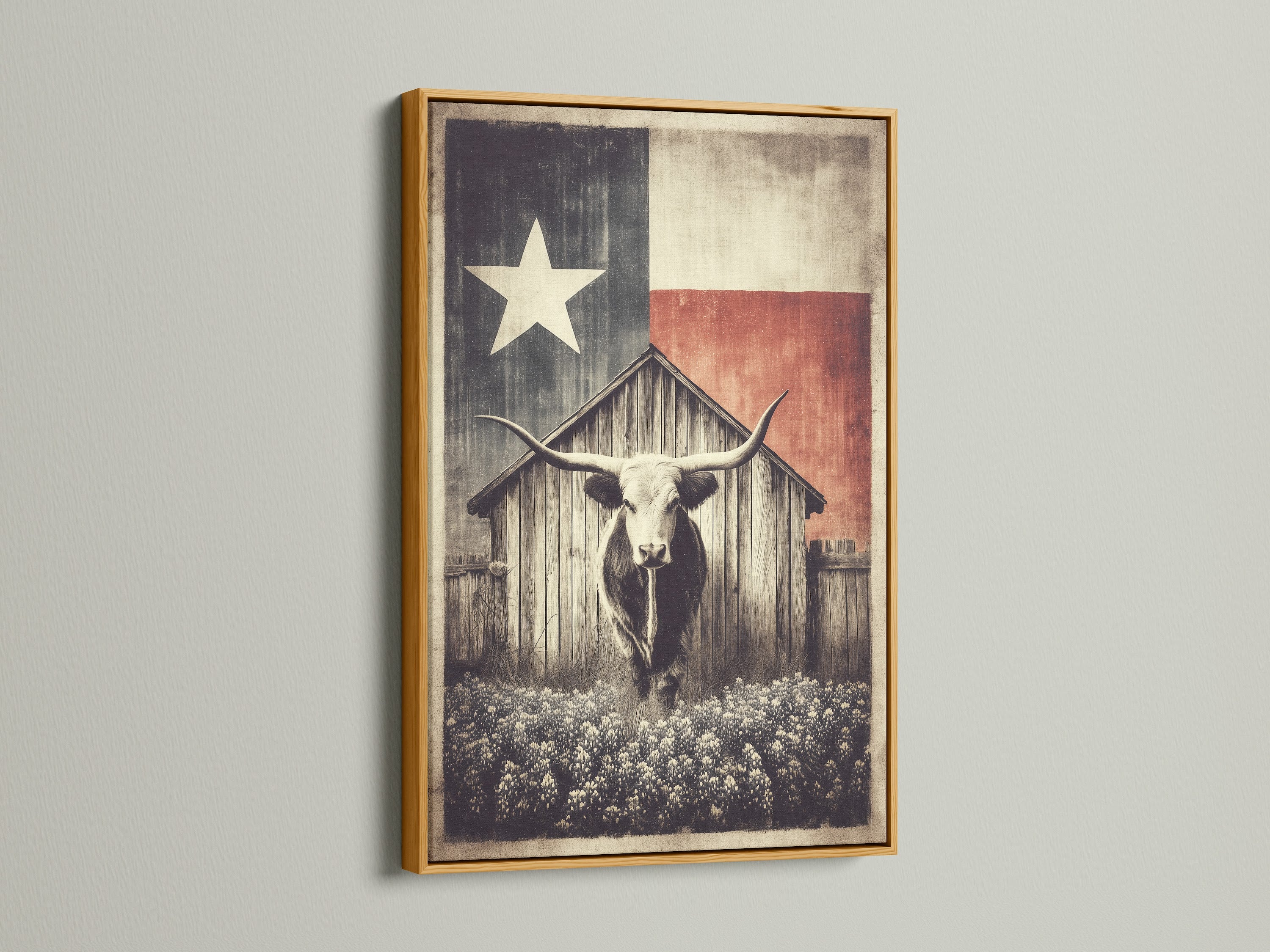 Texas Longhorn art print in a gold frame. The artwork features a longhorn in front of a wooden barn. A Texas flag is behind the barn. This rustic farm wall art brings vintage western decor to any space. The gold frame provides a luxurious touch.