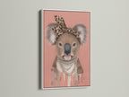 White Frame showcases the Koala Wall Art a trendy nursery piece. The art features a Koala with a leopard print headband and pearl necklace. This quirky animal print adds style to any kids' room wall.