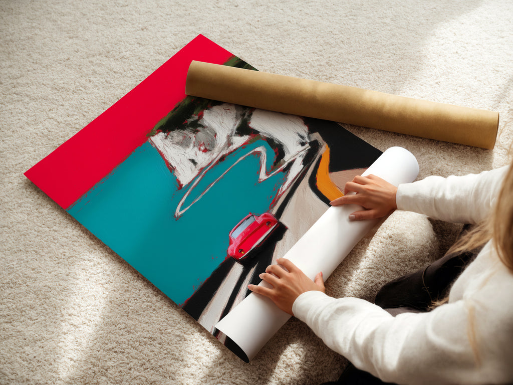 A woman is carefully rolling a fine art poster paper of the coastal road artwork. The poster features a red car on a scenic coastal route. This fine art poster is perfect for travel lovers and car enthusiasts. Get ready to add a touch of mid-century modern flair to your space.