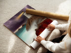 A woman carefully rolling a fine art poster paper. She is preparing it for framing. High quality fine art paper ensures a stunning print. Explore our selection of coastal art prints. Perfect for any space.