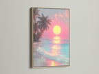 Tropical beach art in an oak frame.  The artwork features a pink sunset over the ocean. Gentle waves roll onto the shore. A beautiful and calming piece of art to enhance your space.