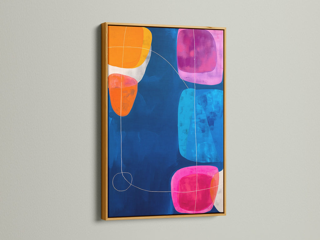 Abstract Geometric Print in a Gold Frame. The modern canvas art features a navy blue background with geometric shapes in pink orange and blue. Elevate your office wall decor with this vibrant art print. This abstract artwork is perfect for contemporary spaces