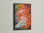 This image features an abstract brushstroke artwork in a sleek black frame. The contrast between the colorful orange and red artwork and the black frame is striking. It is a bold choice for modern wall decor and adds sophistication to any space.
