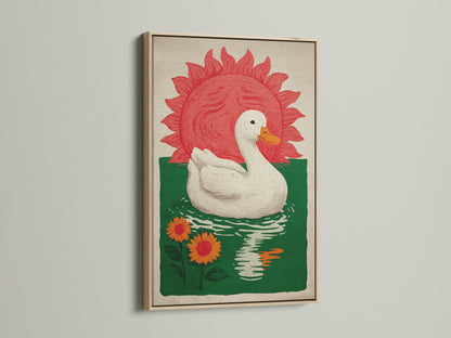 Bohemian Style Wall Art in an oak frame. The art features a white duck floating on green water with orange sunflowers. A red sun is in the background. This nature canvas would be great for a dining area. Consider this bohemian decor for farmhouse rustic or eclectic styles.