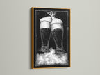 Gold frame artwork. The art features two beer glasses in black and white tones. This piece is mounted on a clean white wall. The frame is a luxurious gold color. Discover framed artwork options to enhance your space. Explore our selection today for the perfect piece.