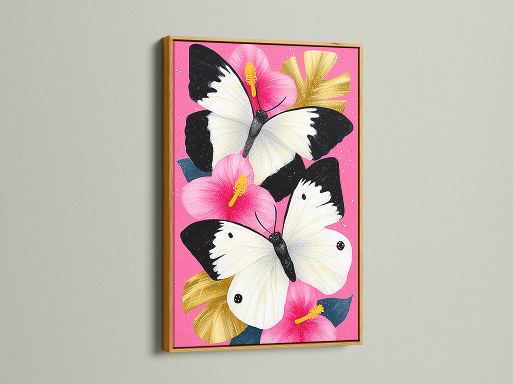 Butterfly Canvas Artwork with a Gold Frame. This stunning piece features a pink hibiscus wall art with white butterflies. Perfect for those seeking elevated wall decor. Add a touch of elegance to your living room or bedroom.