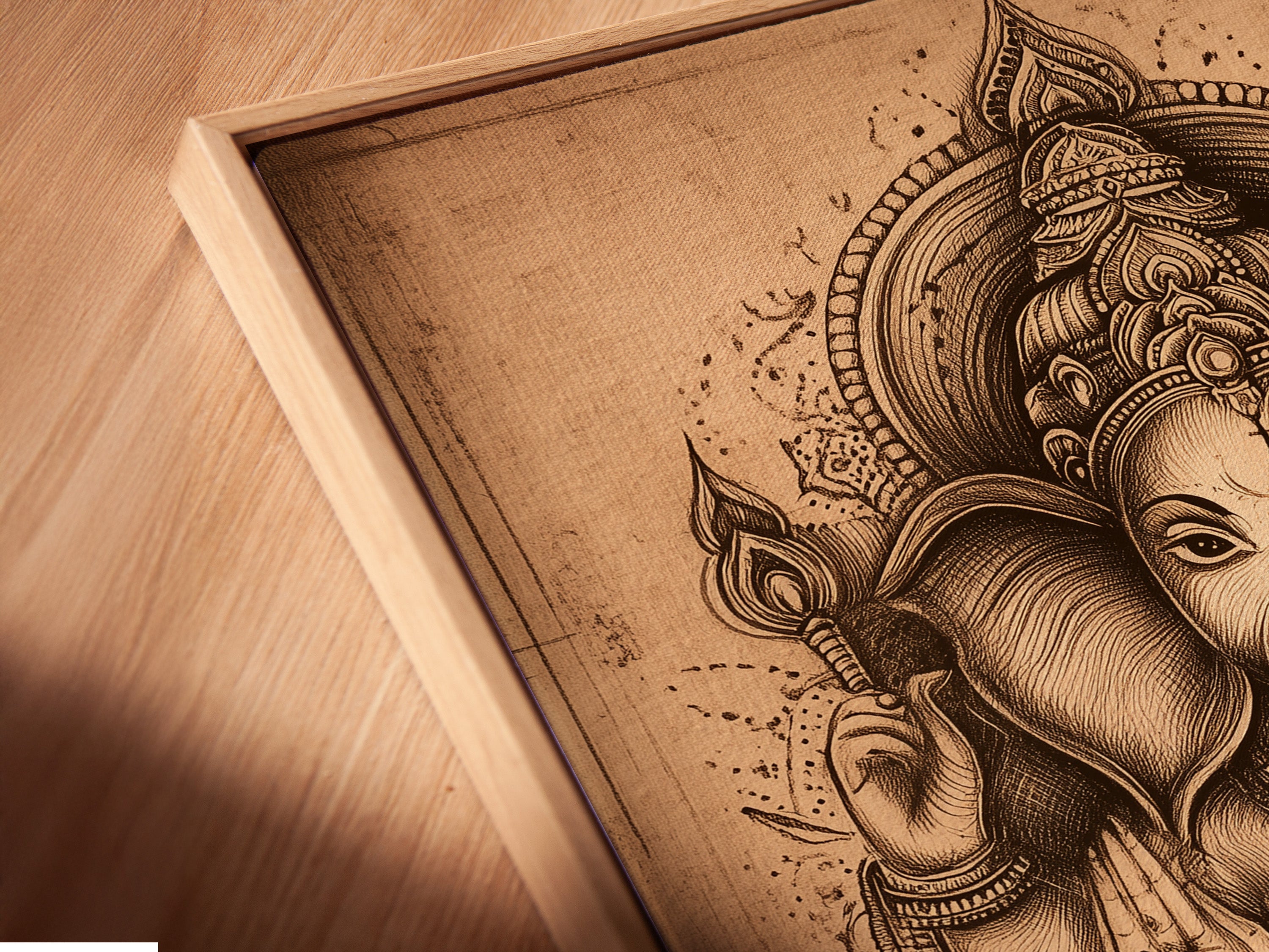 Angled close up of a canvas print in a floating frame. This Ganesha Wall Art is a vintage Hindu canvas print. It offers a modern look for spiritual decor. Perfect for meditation room art or yoga studio decor.