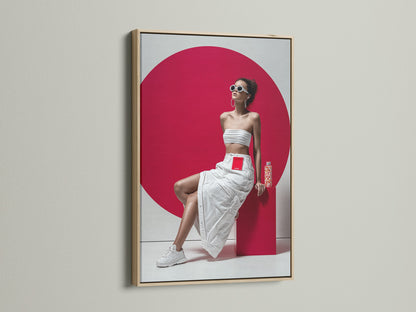 A modern pop art canvas print with an oak frame. The artwork features a woman in a white outfit and a bold red background. This portrait print is ideal for adding a contemporary touch to any living room or studio wall. 