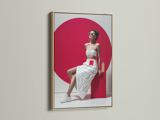 A modern pop art canvas print with an oak frame. The artwork features a woman in a white outfit and a bold red background. This portrait print is ideal for adding a contemporary touch to any living room or studio wall. 