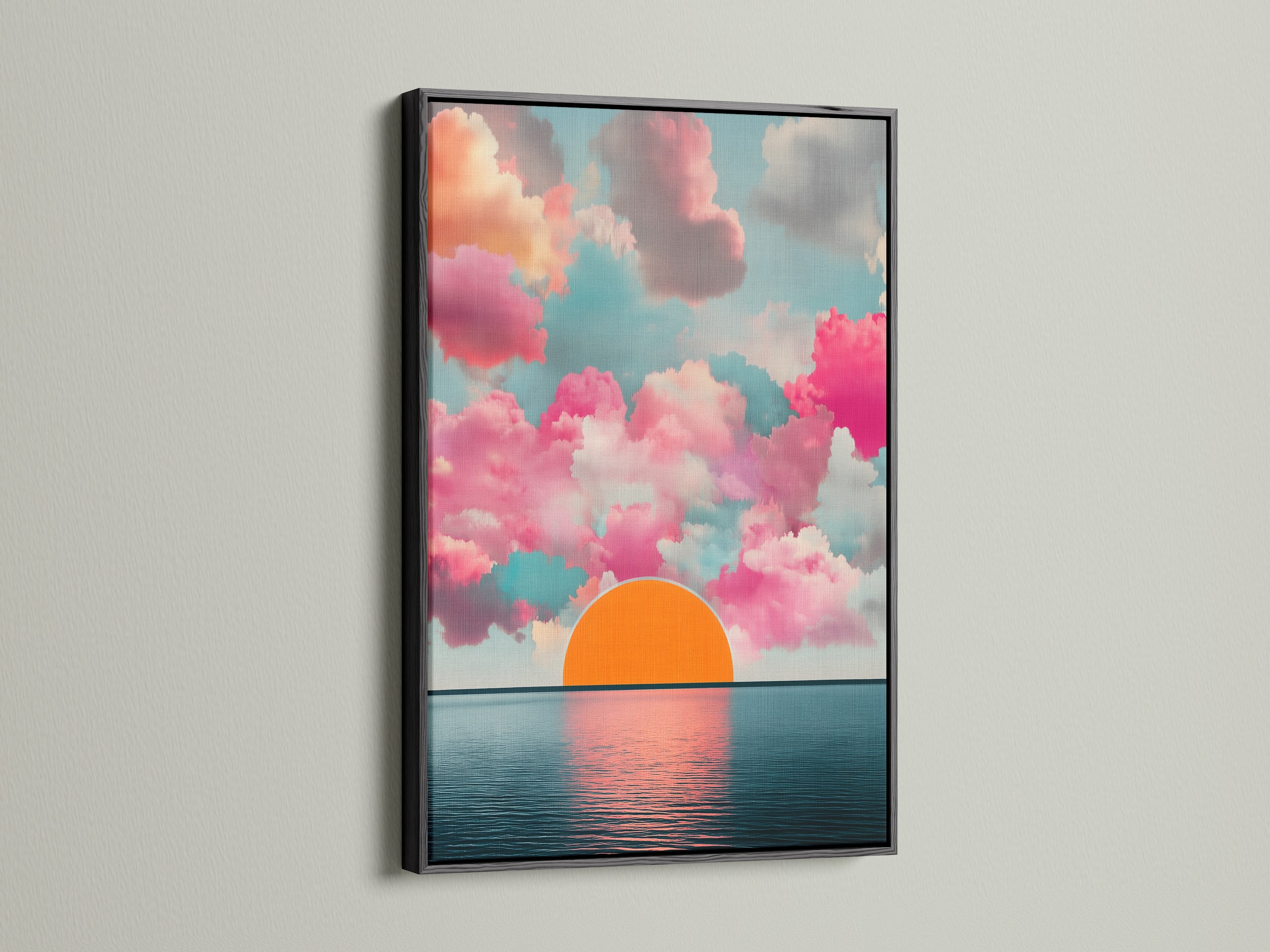 The Sunset Clouds artwork is displayed in a black frame. This modern artwork features pink clouds and a calming horizon print. The seascape canvas is perfect for living room wall art. Add a touch of sunrise art to your home decor.