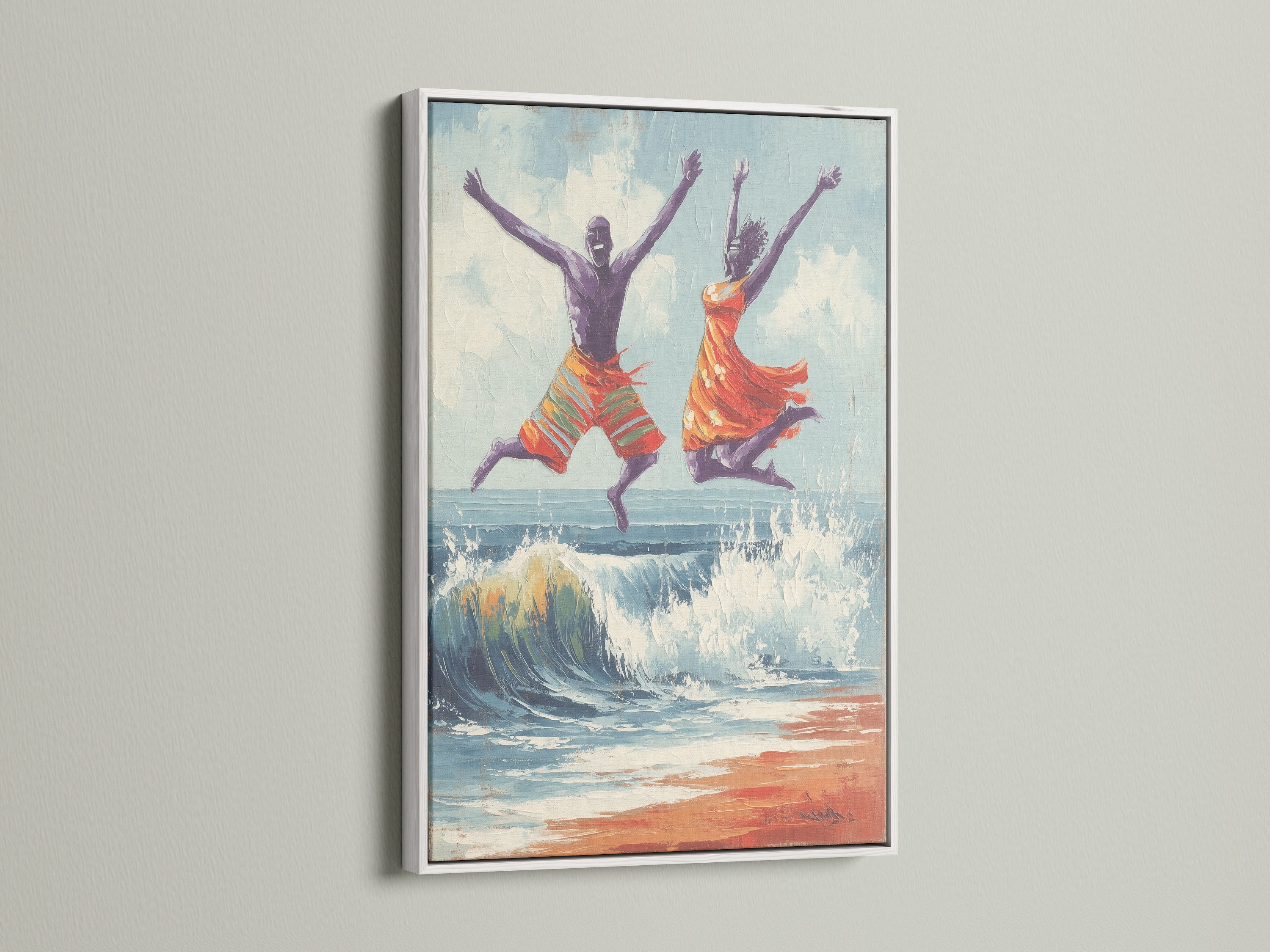 Joyful seascape wall art in a white frame. The artwork features a man and women jumping over a wave on the beach. The white frame offers a clean modern look. Order this summer wall art today