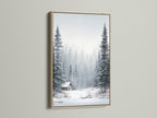 Winter Forest artwork showcased in an oak frame. The artwork features a serene snow landscape. Pine trees surround a cozy cabin. This framed art enhances rustic and Scandinavian-themed rooms. Add warmth to your home today.