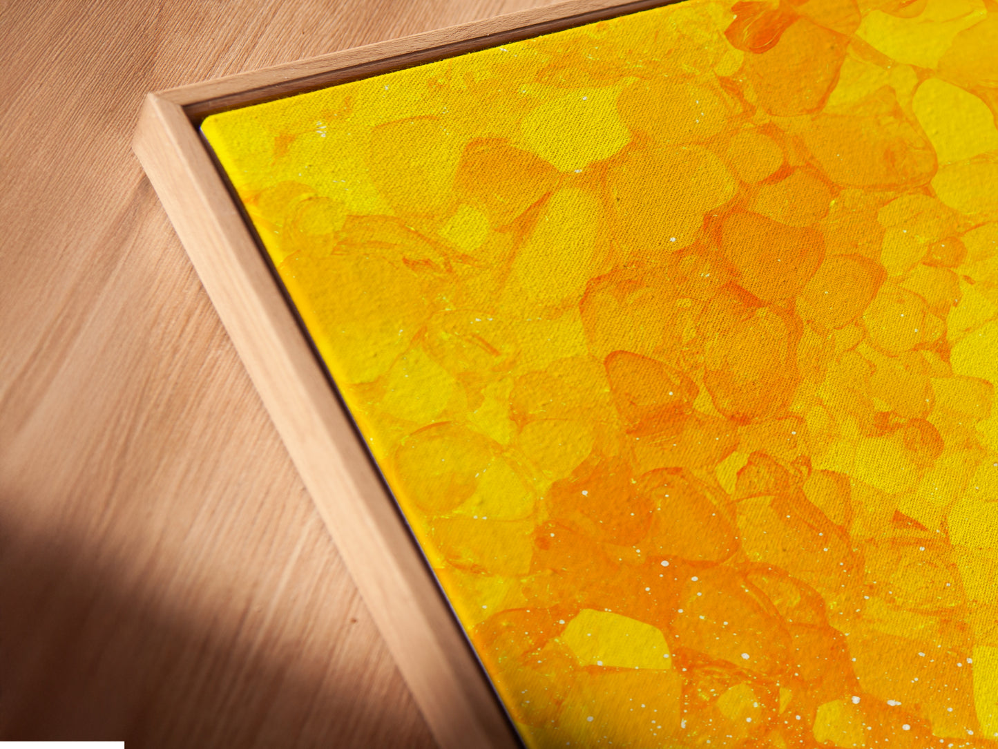 Close-up of a surfing canvas print in a floating frame. The artwork captures a surfer against a vibrant yellow sunset. The floating frame enhances the art. Perfect for coastal decor and adding a beachy vibe to any space. This ocean canvas is ideal for surf enthusiasts.