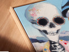 Close-up of a canvas print in a floating frame. The angle highlights the texture and details of the gothic decor. This Dia de los Muertos artwork adds depth and interest to any wall. Perfect for art lovers.