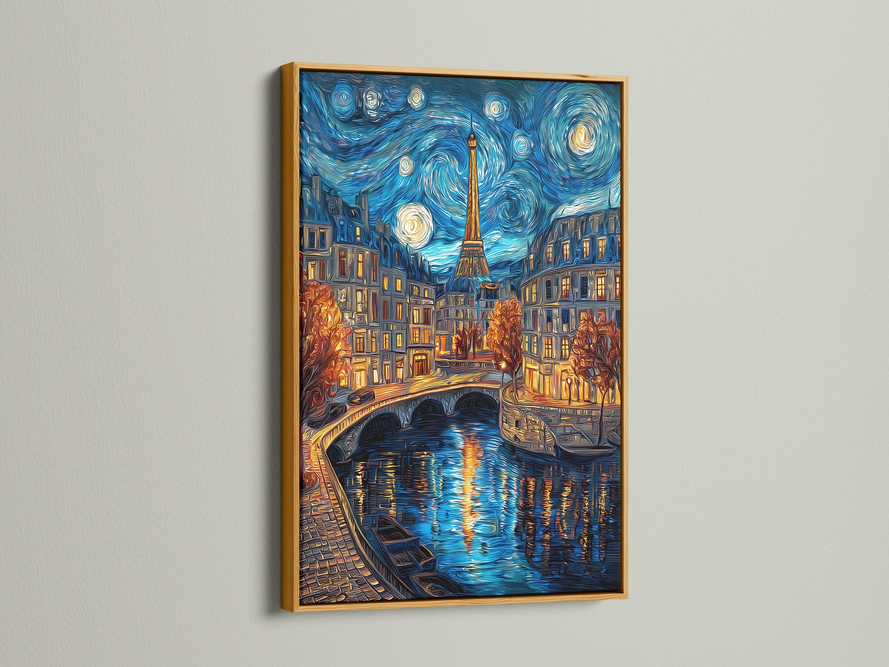 Artwork with a gold frame hanging on a white wall. The art piece is a night scene with the Eiffel Tower in Paris. The artwork is reflecting on the water. The gold frame gives a luxurious look. This is a beautiful piece to add to your art collection.