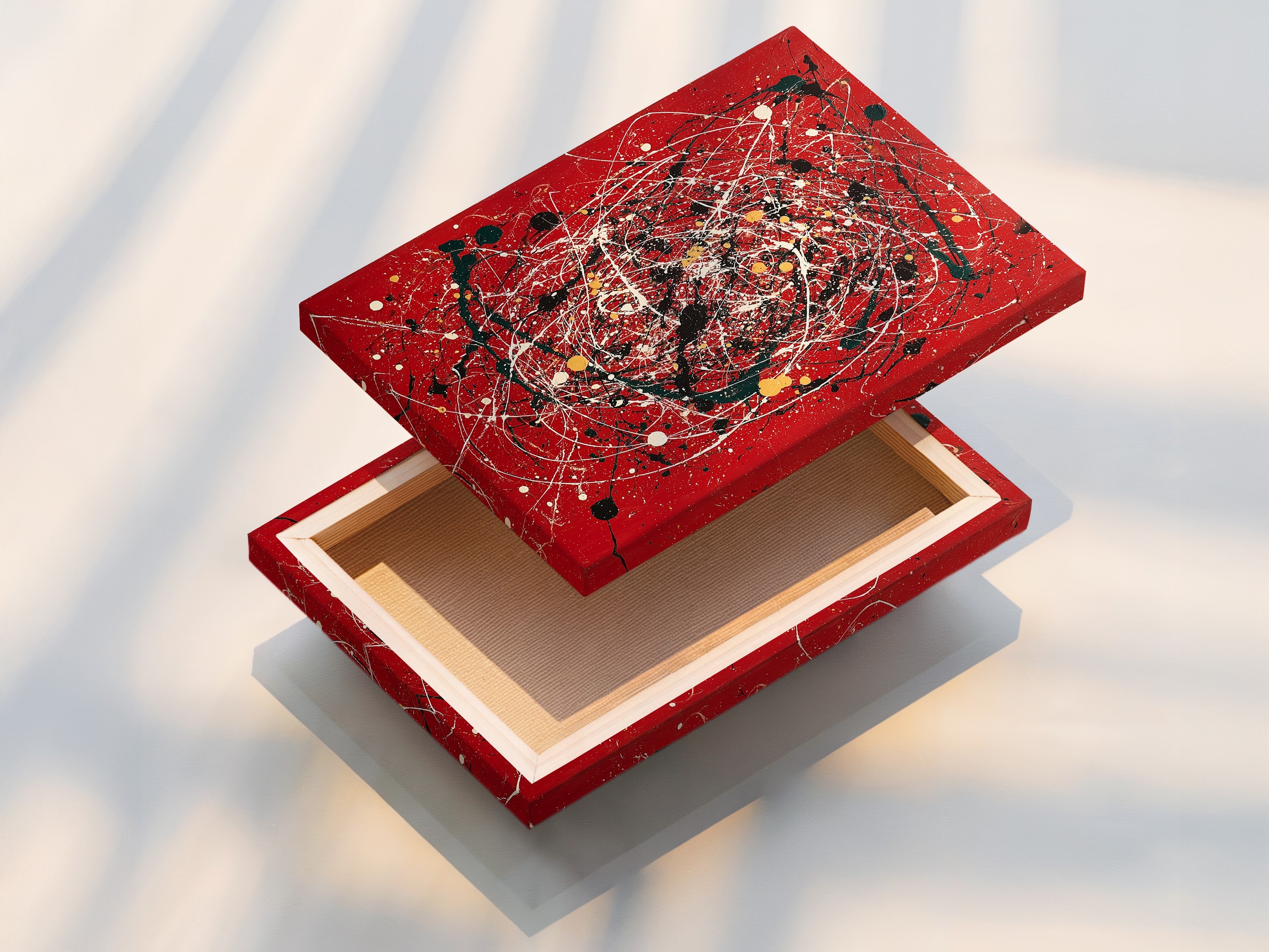 A stretched canvas print featuring vibrant abstract splatter art. The red canvas is bold and eye-catching. Modern paint drip effects create a contemporary look. This artwork is perfect for adding a statement to your walls. Ideal for living rooms offices and modern interiors. Elevate your space with this piece.