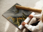 A woman is carefully rolling a fine art poster paper. The poster paper is high quality. It is ready for framing. This image shows the care taken in preparing the artwork. It shows it for display. The process ensures the artwork arrives in perfect condition.