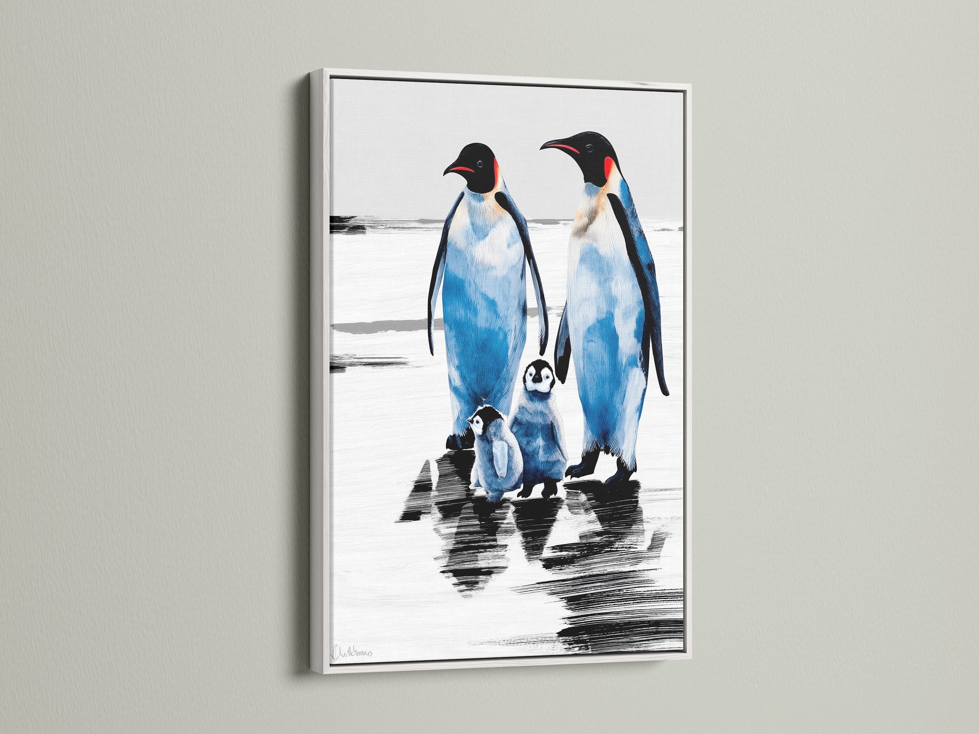 Penguin family portrait in a white frame. This animal artwork is a serene addition to nurseries or children's rooms. The blue and white winter wall art brings an antarctic ocean theme indoors.