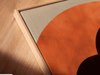 A close-up angled view reveals a canvas print in a floating frame. The artwork features terracotta arches. The floating frame adds depth and dimension. It separates the art from the wall for a gallery-like display.