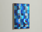 This modern art piece features an abstract blue pattern. The artwork is framed in a light oak. The oak frame enhances the indigo navy print. Perfect for adding a contemporary touch to any room. This geometric wall art is ideal for coastal home decor.