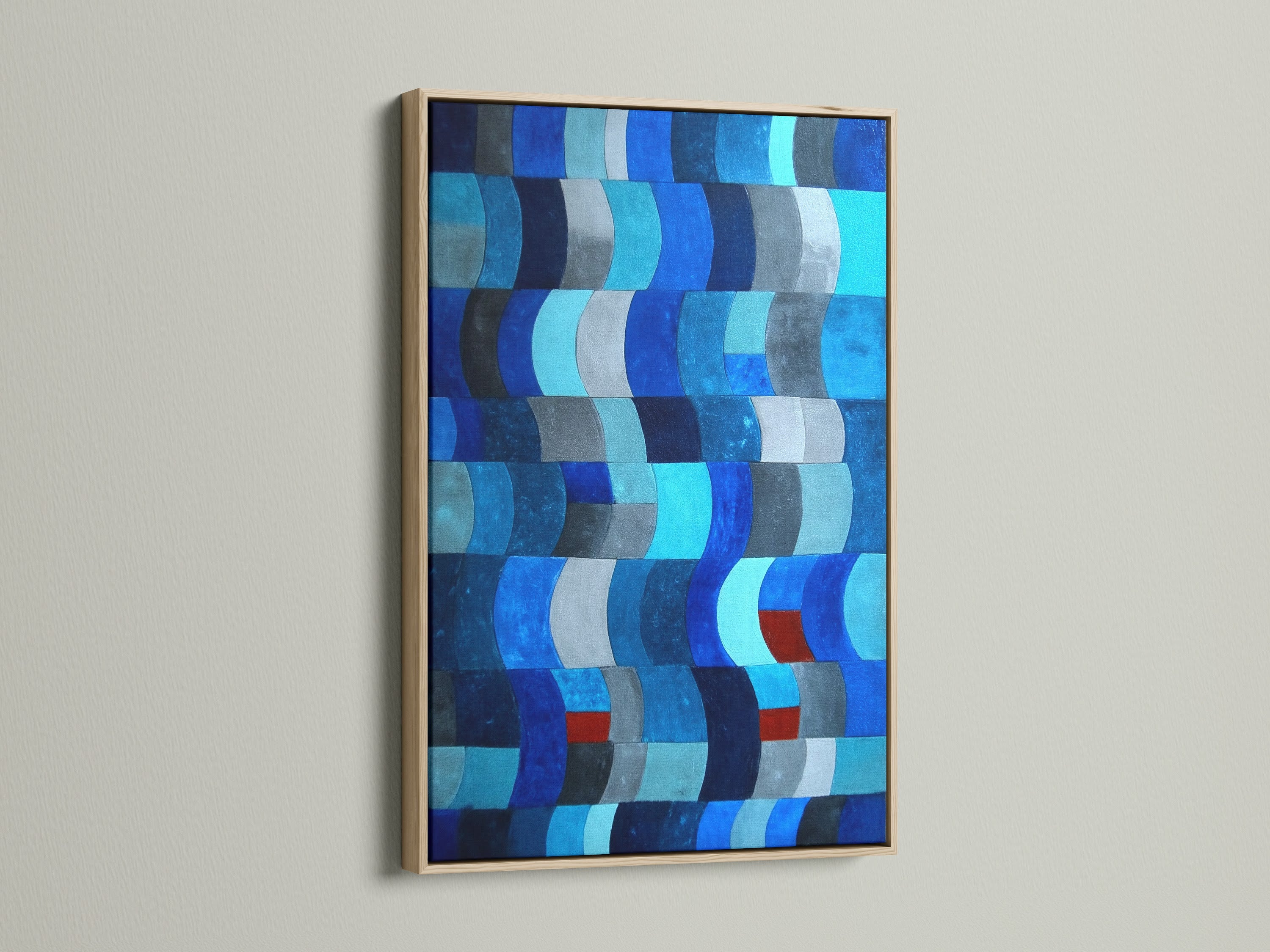 This modern art piece features an abstract blue pattern. The artwork is framed in a light oak. The oak frame enhances the indigo navy print. Perfect for adding a contemporary touch to any room. This geometric wall art is ideal for coastal home decor.
