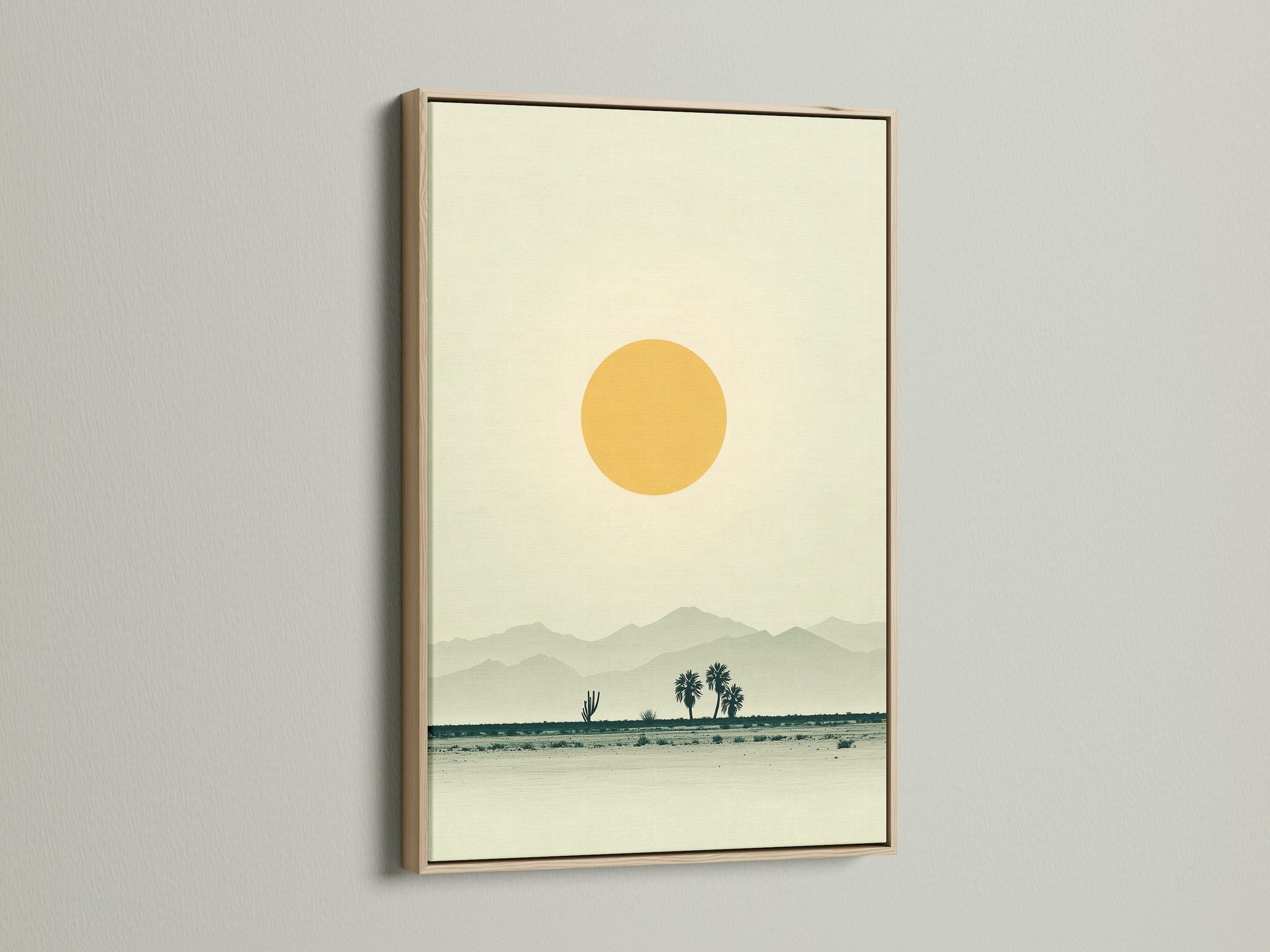 This is a desert landscape canvas print. The artwork is displayed in an oak frame. The print has warm earth tones. It is minimalist wall art. The artwork brings southwestern decor to a home office. It creates a calming and inviting atmosphere.