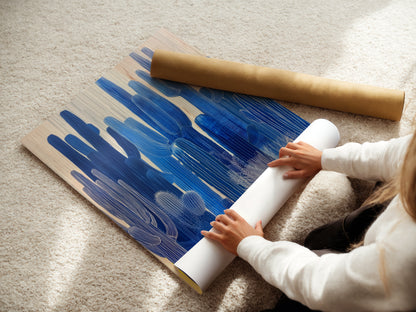 A woman is carefully rolling a fine art poster paper. High-quality materials ensure your cactus art arrives in perfect condition. We provide exceptional care for every desert canvas and botanical print. 