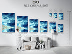 A size comparison chart is displayed in an interior setting. This chart helps visualize the artwork's dimensions. Perfect for planning your wall decor. Available sizes ensure the perfect fit for any space. The artwork is a seascape with a teal sky and birds.