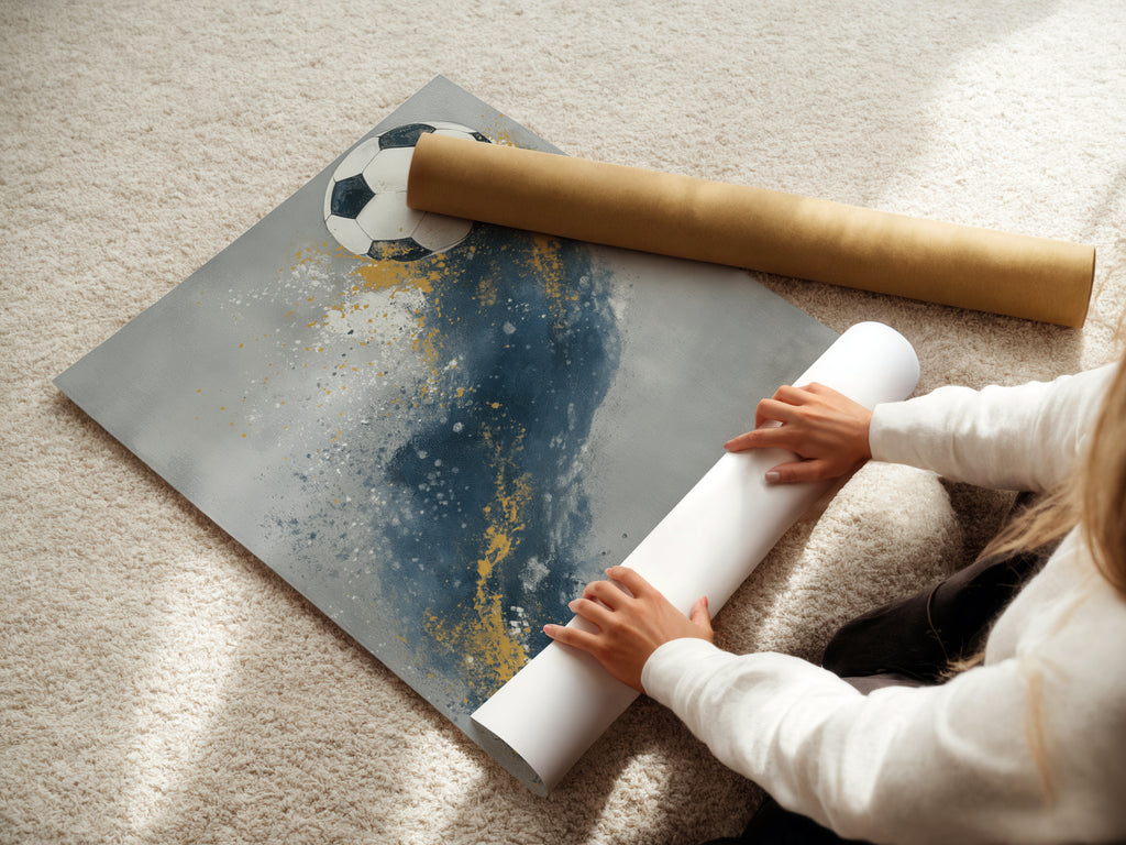 A woman is carefully rolling a fine art poster paper print. The soccer artwork is ready for framing. It features a blue and gold abstract design. The poster paper ensures high quality reproduction. Perfect for sports enthusiasts and art lovers. Add this to your collection.