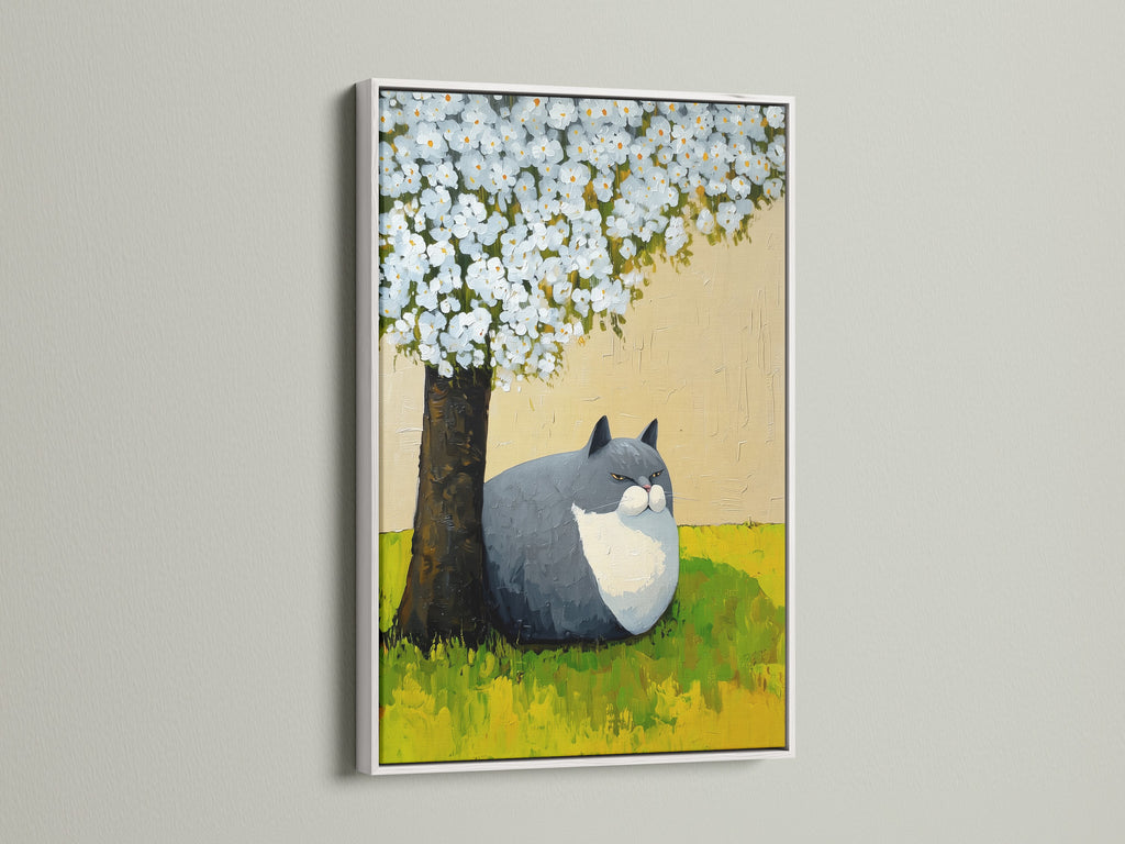 The image shows a delightful cat under tree artwork in a white frame. It is a whimsical nursery art suitable for contemporary interiors. This floral animal art adds a fresh spring wall decor touch. It is ideal for homeowners seeking unique animal-themed wall art.