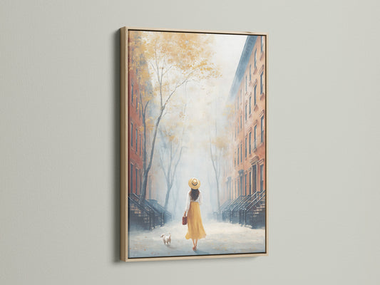 City Street artwork in an oak frame. The artwork portrays a serene street scene with a woman and her dog. The golden hour lighting adds warmth. It's ideal as living room wall art. Elevate your space with this cityscape art print.