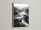 This is an oak frame displaying black and white ocean wave artwork. The natural wood grain adds warmth to monochrome art. Perfect nautical decor for a modern home. Discover seascape canvas prints now.