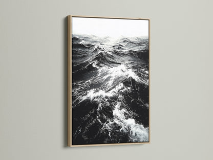 This is an oak frame displaying black and white ocean wave artwork. The natural wood grain adds warmth to monochrome art. Perfect nautical decor for a modern home. Discover seascape canvas prints now.