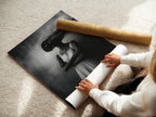 A woman rolls a fine art poster paper. She is preparing a surreal woman print. This black and white photography poster is ready for framing. Get your dreamy artwork and enhance your space now