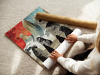 A woman is carefully rolling a fine art poster paper print. This high-quality print features a surreal stone figures art. The abstract landscape artwork is perfect for any art lover. It is ideal for modern wall decor.
