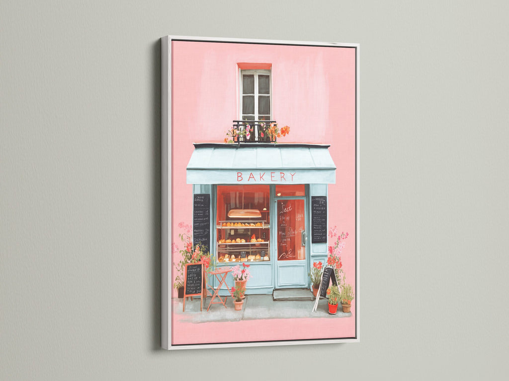 Artwork showcased in a white frame. The art features a delightful bakery scene painted in soft pinks and blues. The white frame provides a clean and modern look. This artwork will add a touch of elegance to any room. It is ideal for a serene atmosphere.