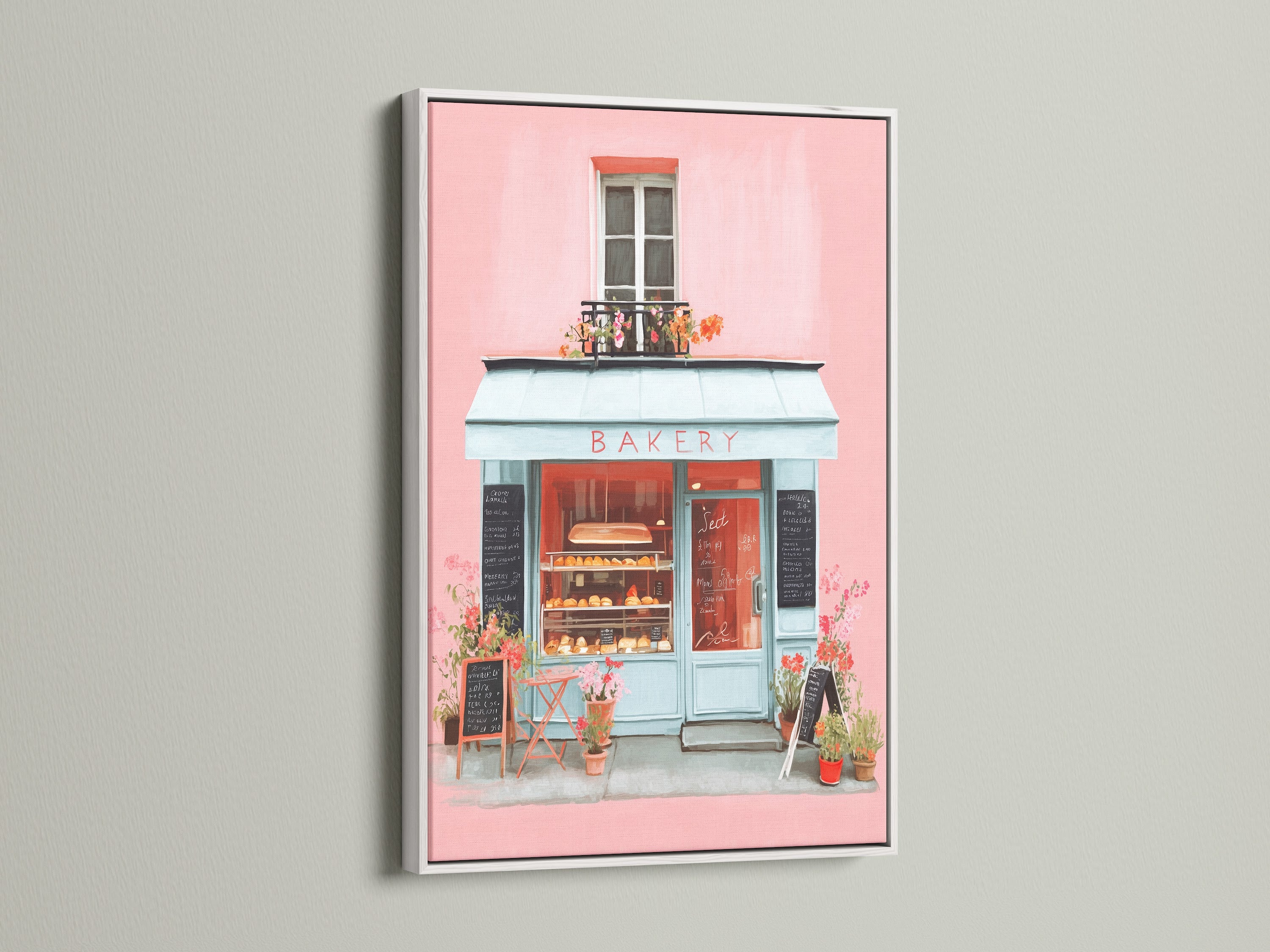 Artwork showcased in a white frame. The art features a delightful bakery scene painted in soft pinks and blues. The white frame provides a clean and modern look. This artwork will add a touch of elegance to any room. It is ideal for a serene atmosphere.