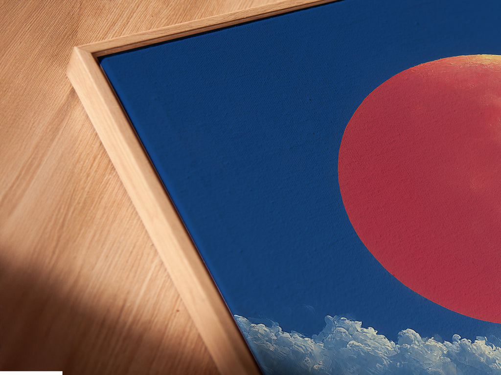 A close-up of the canvas print in a floating frame. The ski resort artwork is displayed at an angle. The mountain landscape and coral moon are clearly visible. It adds depth and dimension to any room. The floating frame creates a modern look.