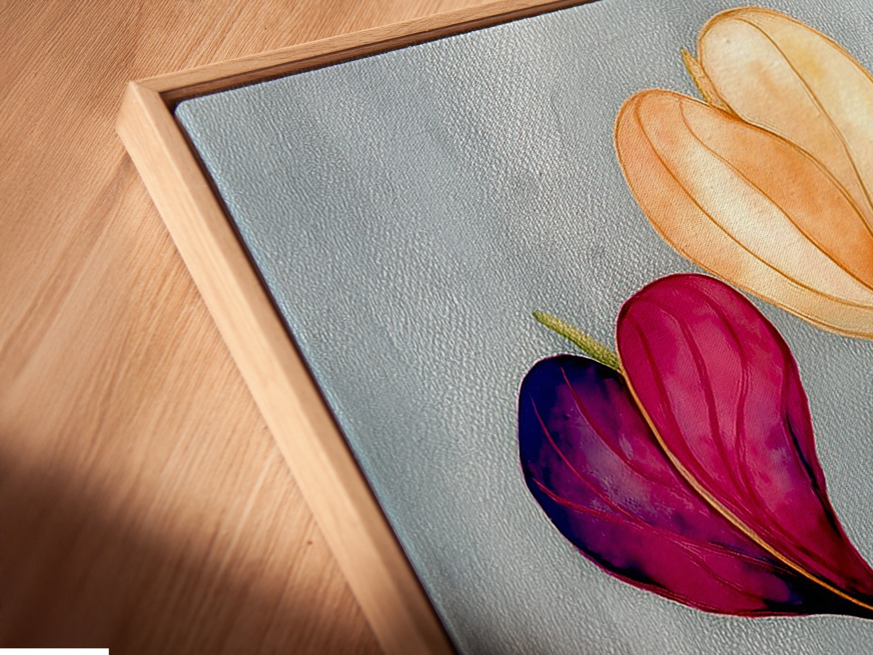 Angled close up shows a canvas print in a floating frame. The floral watercolor design is visible. The pastel botanical wall artwork enhances any space. It is a modern flower artwork for the bedroom and is perfect for adding a sophisticated touch.