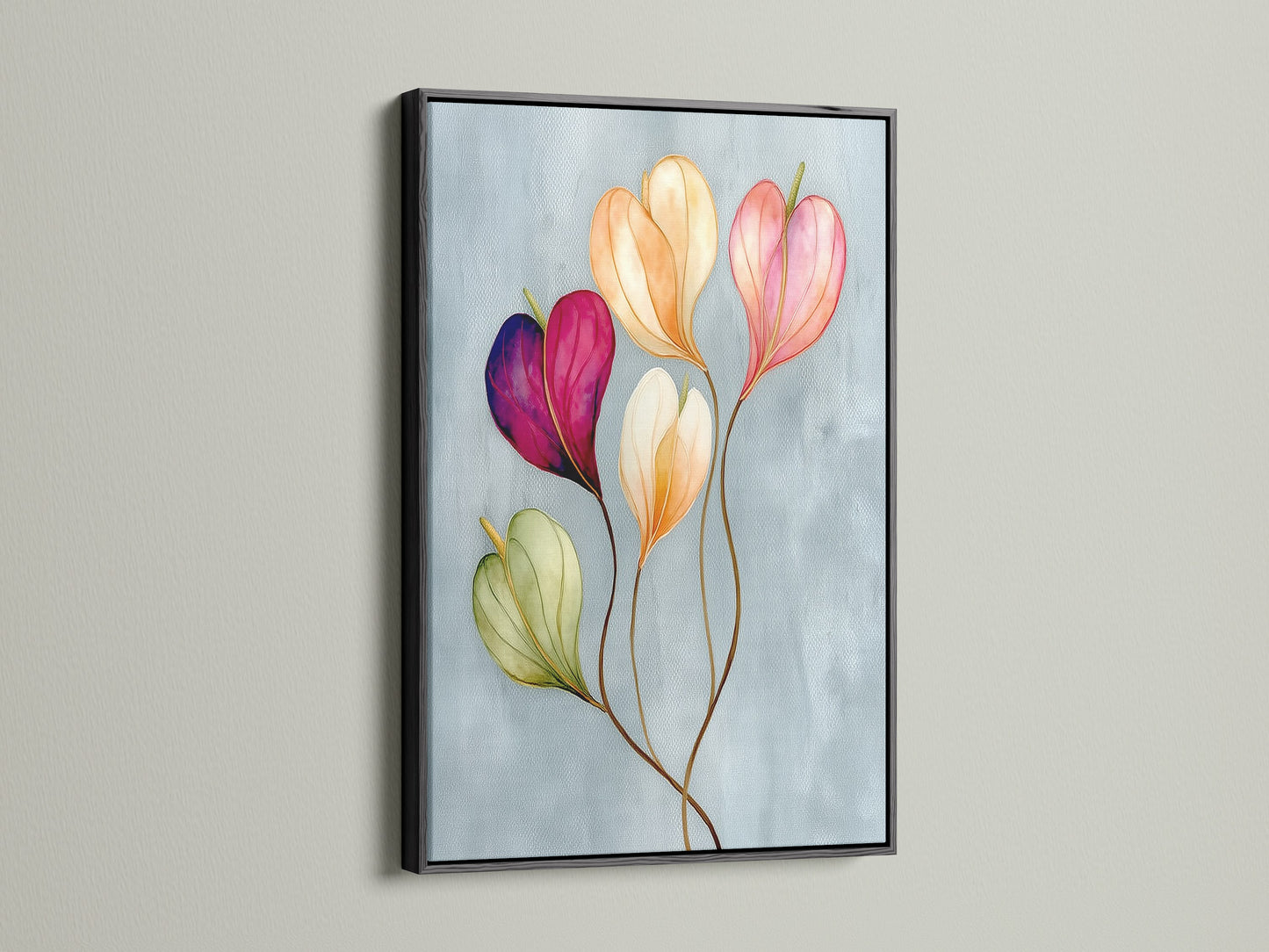Floral watercolor canvas print in a black frame is displayed. This pastel flower art is a sophisticated touch for any room. The flower artwork brings a modern aesthetic to bedroom wall decor. It is perfect for those who love decorating with floral themes.