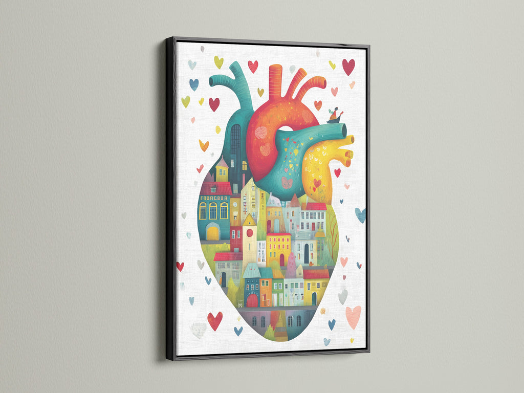 The black frame contrasts beautifully with the colorful anatomical heart art. The artwork features city houses within a heart. It is a unique piece of medical wall art. This contemporary print adds character to any room. The black frame makes the colors pop.