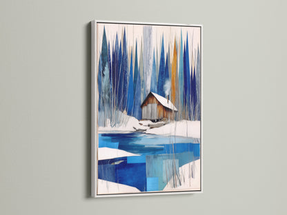 Winter Cabin Canvas Artwork with a white frame. Features snowy lake wall art for chalet decor. The white frame offers a clean crisp look to the blue and white abstract winter art. This modern wall art brightens any nature print. Ideal for lake house decor or winter cabin decor settings.