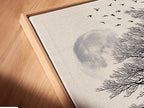 Angled close up of a canvas print in a floating frame. This wolf and moon art makes a statement. The coastal tree artwork is perfect for living rooms or offices. The frame adds a modern touch.