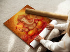 A woman carefully rolls a fine art poster paper featuring Ganesha. The Hindu God wall print showcases golden orange spiritual art. Perfect for meditation rooms and yoga studios. This piece adds an elegant touch.